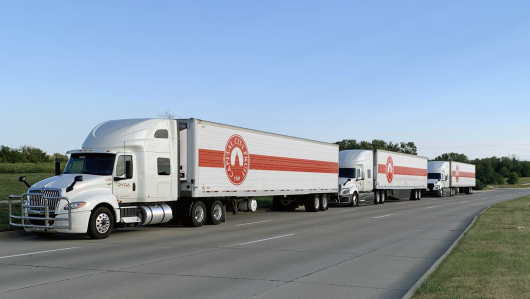 Pyra Logistics hauls Capital City Fruit product—three branded trailers lined up and ready for delivery.